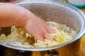 Woman hands baker kneading with raw yellow dough in a kitchen bowl Royalty Free Stock Photo