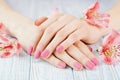 Woman hands with beautiful pink matted manicure