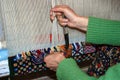 Woman hands weaving a carpet