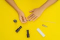 Woman Hands Care. Top View Of Beautiful Smooth Woman`s Hands With Professional Nail Care Tools For Manicure On yellow Royalty Free Stock Photo