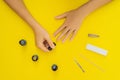 Woman Hands Care. Top View Of Beautiful Smooth Woman`s Hands With Professional Nail Care Tools For Manicure On yellow Royalty Free Stock Photo