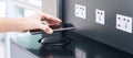 Woman hands charging battery in mobile smart phone by wireless charger at international airport terminal. Technology, multiple