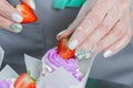 Woman hands chef decorating Cupcakes with pink butter cream and fresh berries Royalty Free Stock Photo