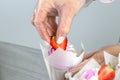 Woman hands chef decorating Cupcakes with pink butter cream and fresh berries Royalty Free Stock Photo