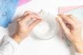 Woman hands cleaning golden jewelry at home. Top view