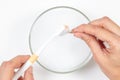 Woman hands cleaning golden jewelry with soapy water and toothbrush at home. Top view