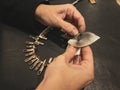 Woman hands cleaning silver necklace with cloth