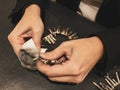 Woman hands cleaning silver necklace with cloth