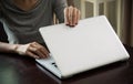 Woman hands close a laptop at home in day time focus hand