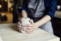 Woman hands close-up, forming crude clay in a potter`s workshop studio. Craft-work. Royalty Free Stock Photo