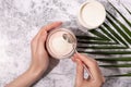 Woman hands, collagen powder and smoothie