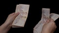 Woman hands counting of thousands Thai baht banknotes money.