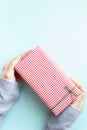 Woman`s hands in sweater holding gift box Royalty Free Stock Photo