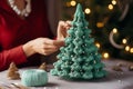 Woman hands crochet a Christmas tree decoration - xmas ornament gift wrapping - hobby