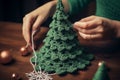 Woman hands crochet a Christmas tree decoration - xmas ornament gift wrapping - hobby