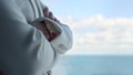 Woman hands crossing ocean view closeup. Sea business trip vacations concept