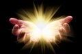 Woman hands cupped holding, showing, or emanating bright, glowing, radiant, shining light. Royalty Free Stock Photo