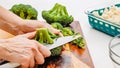Woman hands cut broccoli into florets, close up cooking process Royalty Free Stock Photo