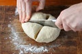 Woman hands cutting dough
