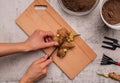 Woman hands cutting ginger root for planting top view