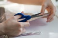 woman hands cutting paper material with scissors Royalty Free Stock Photo