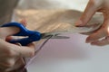 woman hands cutting paper material with scissors Royalty Free Stock Photo