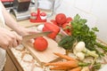 Woman hands cutting ripe tomato