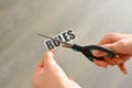 Woman hands cutting with scissors a printout reading 