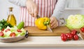 Woman hands cutting vegetables on board in kitchen cooking salad Royalty Free Stock Photo