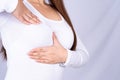 Woman hands doing breast self exam for checking lumps and signs of breast cancer on grey background. Medical, healthcare for Royalty Free Stock Photo