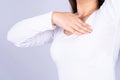 Woman hands doing breast self exam for checking lumps and signs of breast cancer on grey background. Medical, healthcare for Royalty Free Stock Photo