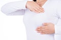 Woman hands doing breast self exam for checking lumps and signs of breast cancer isolated over white background. Medical, Royalty Free Stock Photo