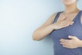 Woman hands doing breast self-exam for checking lumps and signs of breast cancer on white background. Health care and medical