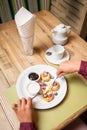 Woman hands eating cottage cheese pancakes Royalty Free Stock Photo