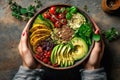 Woman hands eating vegan salad of baked vegetables, avocado, tofu and buckwheat buddha bowl, top view