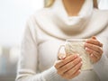 Woman hands with elegant french manicure nails design holding a cozy knitted mug. Winter and Christmas concept. Royalty Free Stock Photo