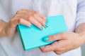 Woman hands with elegant turquoise manicure