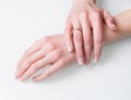 Woman hands with engagement ring on white