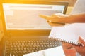 Woman hands finger point to laptop on wooden desk, lighting effect