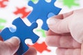 Woman hands fitting jigsaw puzzle pieces together Royalty Free Stock Photo