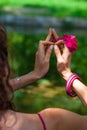 Woman hands with flower in yoga mudra gesture outdoor in nature Royalty Free Stock Photo