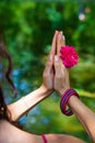 Woman hands with flower in yoga mudra gesture outdoor in nature Royalty Free Stock Photo