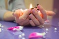 Woman hands with french manicure holding a candle Royalty Free Stock Photo