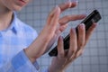 Woman hands using smartphone against tile wall - close up side view Royalty Free Stock Photo