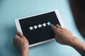 Woman hands give five star rating review on tablet