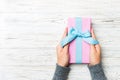 Woman hands give wrapped christmas or other holiday handmade present in colored paper . Present box, decoration of gift on white Royalty Free Stock Photo