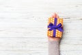Woman hands give wrapped christmas or other holiday handmade present in colored paper . Present box, decoration of gift on white Royalty Free Stock Photo