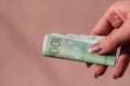 Woman hands giving money like a bribe or tips. Holding EURO banknotes on a blurred background, EU currency Royalty Free Stock Photo