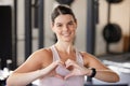Woman, hands and heart shape for exercise at gym for fitness, training workout or healthy lifestyle. Happy athlete