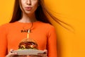 Woman hands hold big burger barbeque sandwich with beef and lit candle for birthday party on yellow Royalty Free Stock Photo